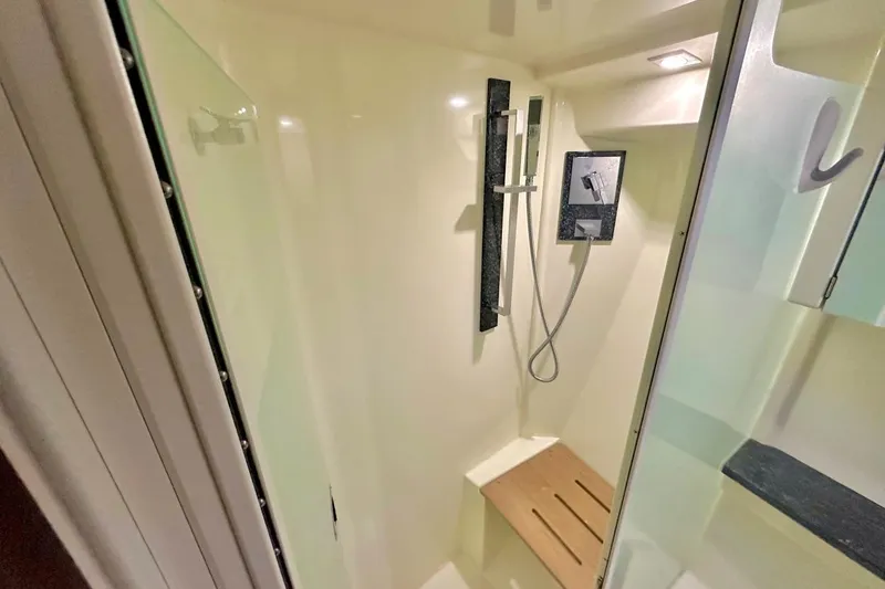 Slide: The Image of Shower area in 2013 Monterey 400 Sport Yacht with modern fixtures and wooden seat. - 12
