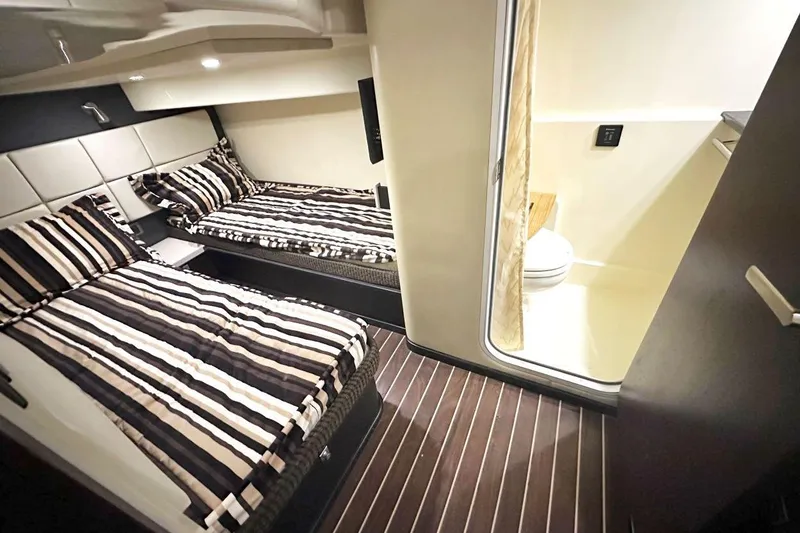 Slide: The Image of 2013 Monterey 400 Sport Yacht interior with twin beds and bathroom. - 15