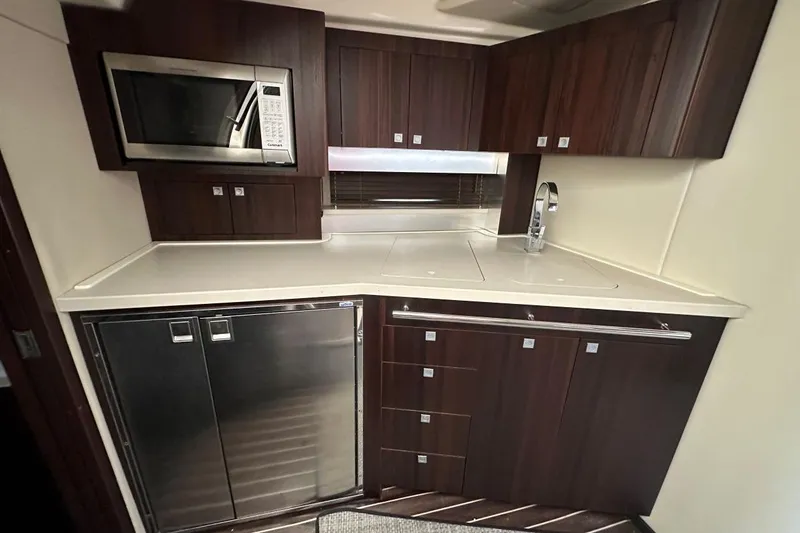 Slide: The Image of Luxurious kitchen in 2013 Monterey 400 Sport Yacht with modern appliances and sleek cabinetry. - 16