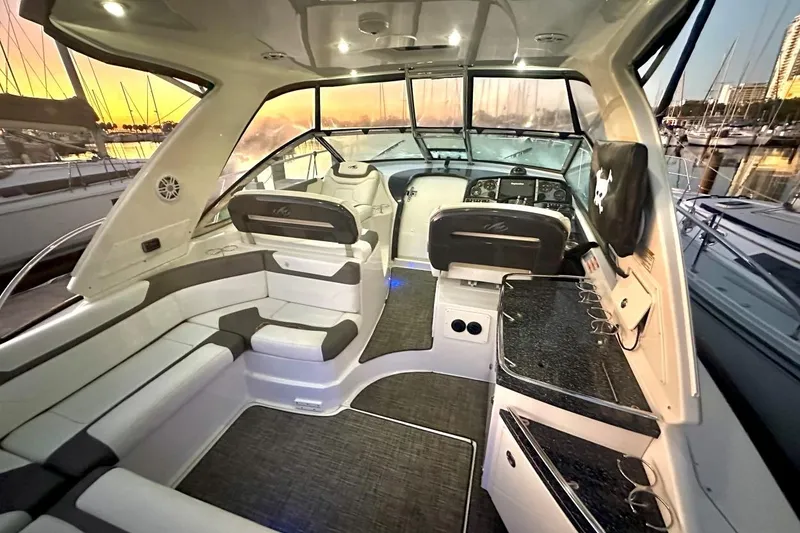 Slide: The Image of Interior of 2013 Monterey 400 Sport Yacht at sunset, featuring sleek seating and modern controls. - 4