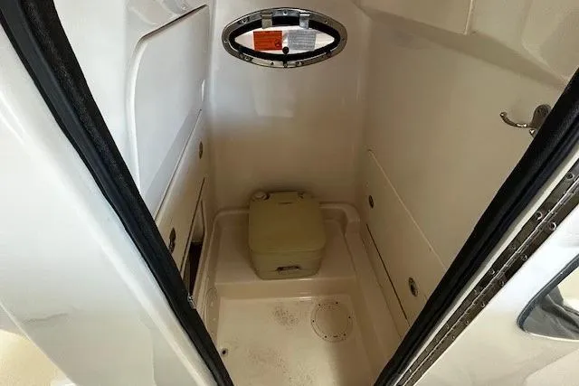 Slide: The Image of 2019 Grady-White Fisherman 236 boat interior with compact marine toilet. - 10