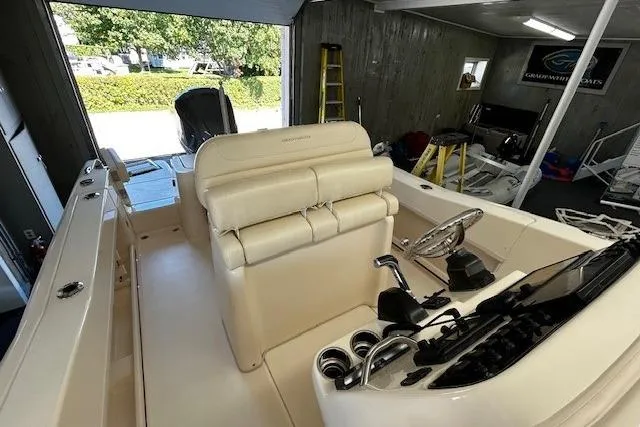 Slide: The Image of 2019 Grady-White Fisherman 236 boat interior with helm and seating in a garage. - 11