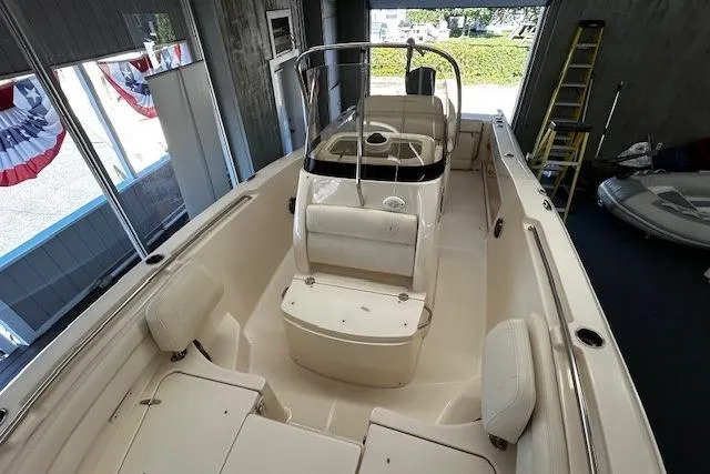Slide: The Image of 2019 Grady-White Fisherman 236 boat interior with seating and console in a showroom. - 4