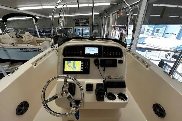 Slide: The Image of 2019 Grady-White Fisherman 236 boat console with navigation screens and steering wheel. - 9