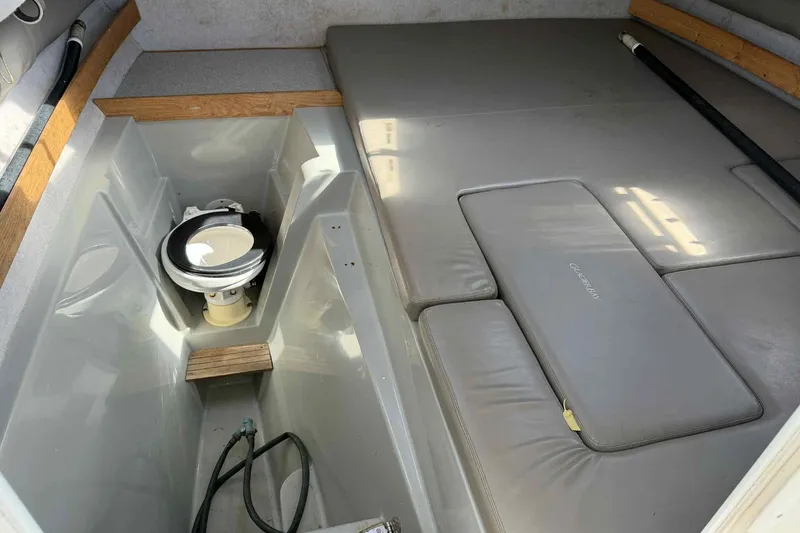 Slide: The Image of 2000 Glacier Bay 2670 Island Runner cabin interior with toilet and cushioned seating. - 12