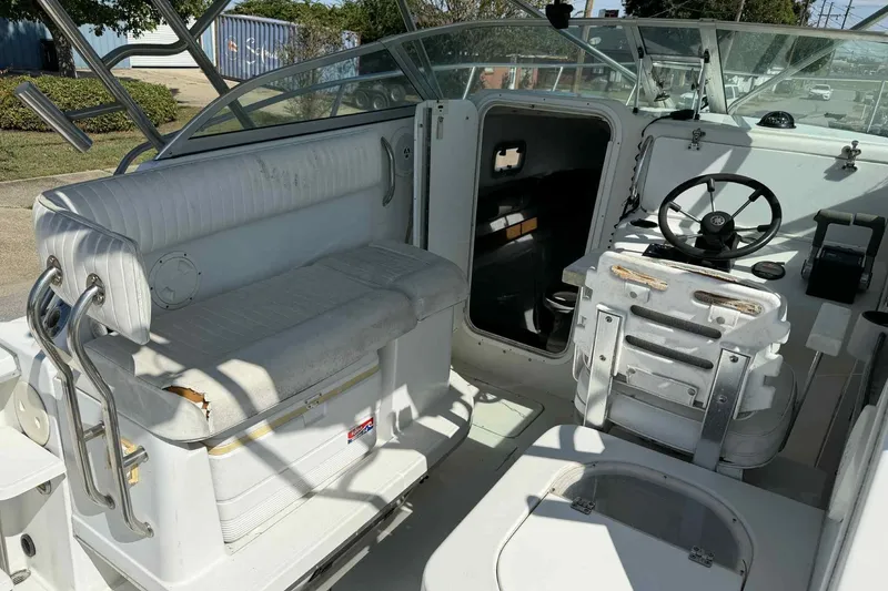 Slide: The Image of 2000 Glacier Bay 2670 Island Runner boat interior with seating and steering wheel. - 14