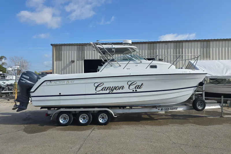 Slide: The Image of 2000 Glacier Bay 2670 Isle Runner boat on trailer, side view, clear sky background. - 27