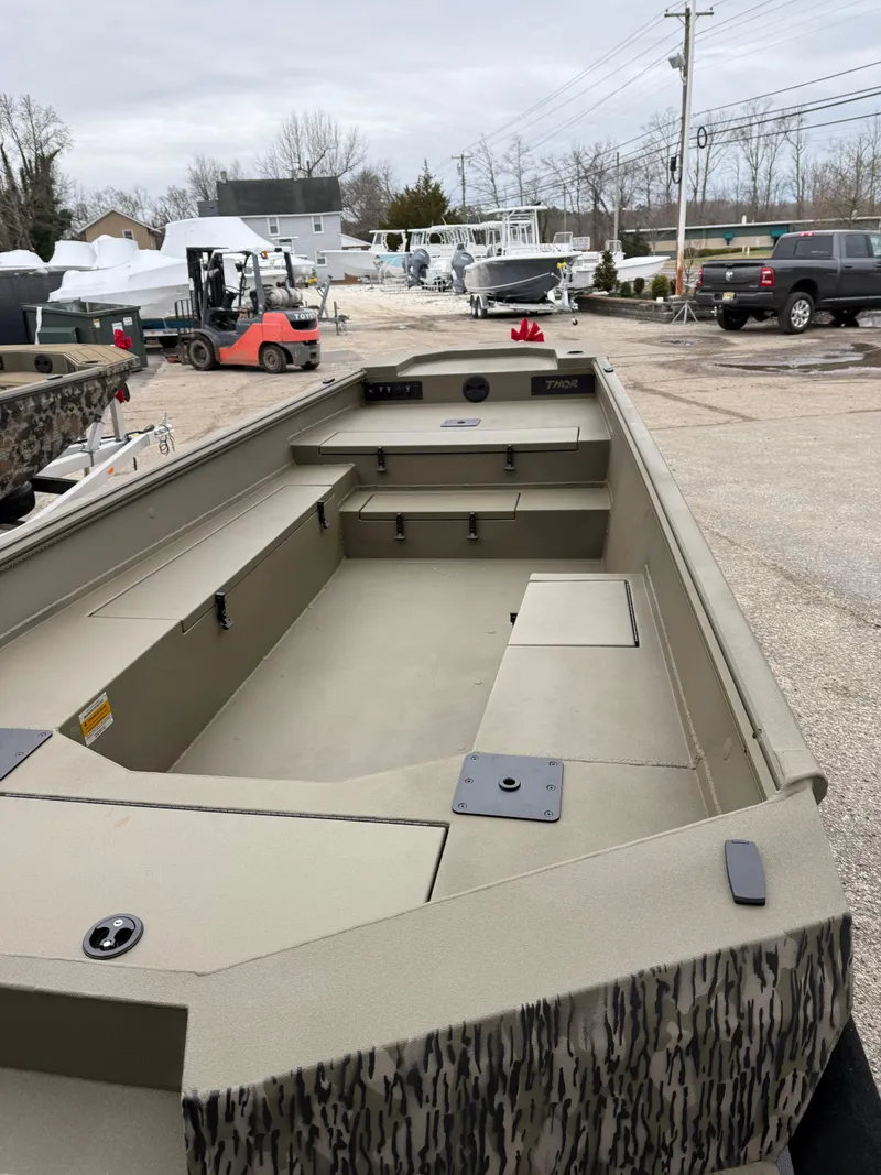 Slide: The Image of 2025 Thor 1754 Lake Hammer boat, spacious interior, parked outdoors. - 5