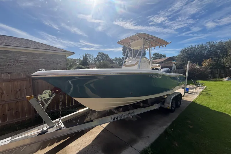 The Image of 2015 Pioneer 222 Sportfish boat on trailer in sunny backyard. - 1