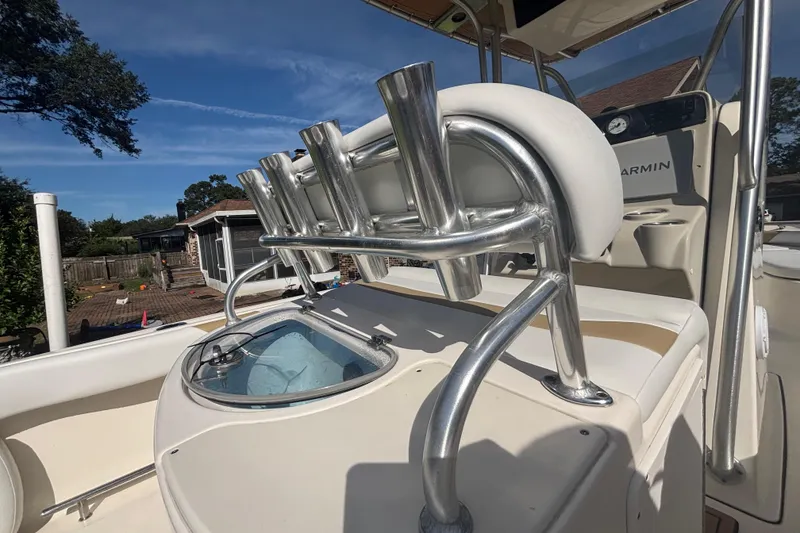 Slide: The Image of 2015 Pioneer 222 Sportfish boat interior with rod holders and Garmin equipment. - 12