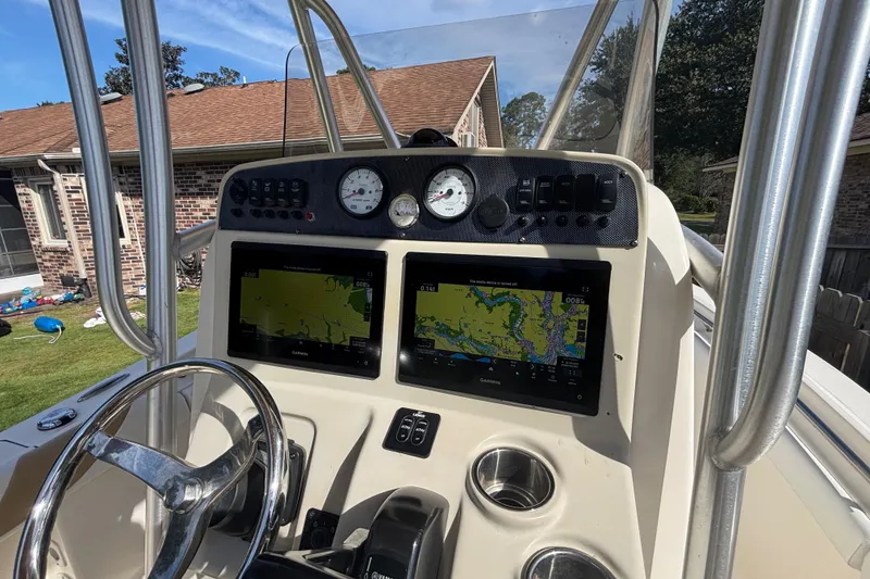 Slide: The Image of 2015 Pioneer 222 Sportfish boat dashboard with navigation screens and gauges. - 16