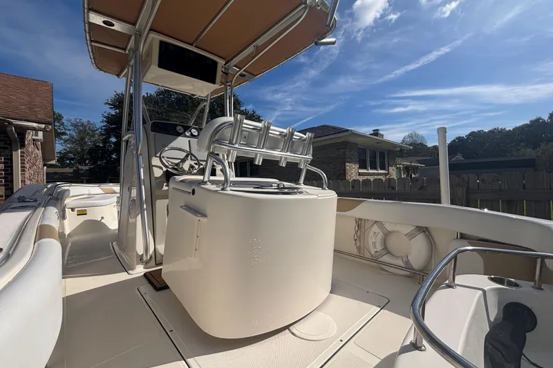 Slide: The Image of 2015 Pioneer 222 Sportfish boat with center console and T-top under a clear blue sky. - 9