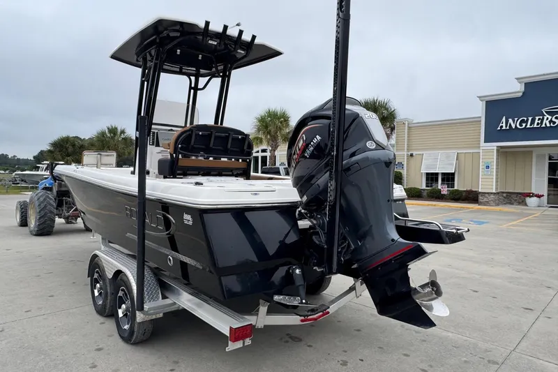 Slide: The Image of 2024 Robalo 226 Cayman boat on trailer, parked outside Anglers store. - 1