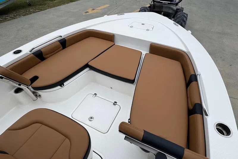 Slide: The Image of 2024 Robalo 226 Cayman boat interior with tan seating and storage compartments. - 11