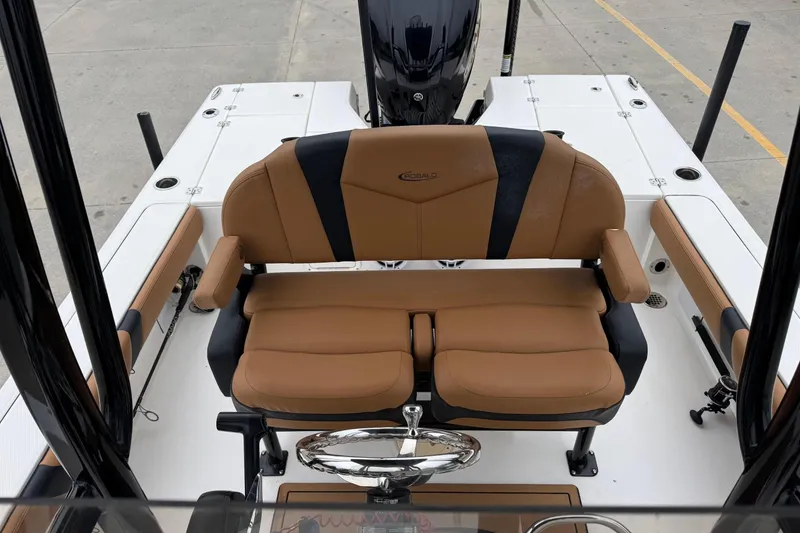 Slide: The Image of 2024 Robalo 226 Cayman boat interior with tan seating and steering wheel. - 13