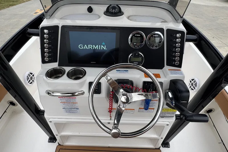 Slide: The Image of 2024 Robalo 226 Cayman boat dashboard with Garmin display and Yamaha controls. - 15