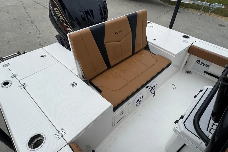 Slide: The Image of 2024 Robalo 226 Cayman boat interior with tan seating and Yamaha engine. - 18