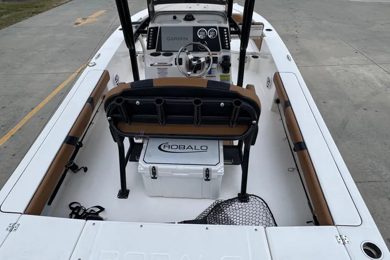 Slide: The Image of 2024 Robalo 226 Cayman boat interior with Garmin navigation system and seating. - 7
