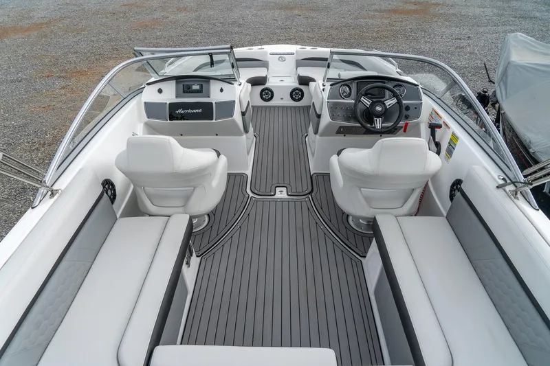 Slide: The Image of 2024 Hurricane SunDeck 217 OB boat interior with sleek seating and modern dashboard design. - 10
