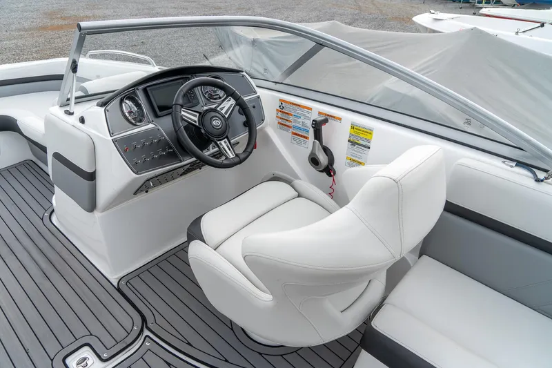 Slide: The Image of 2024 Hurricane SunDeck 217 OB boat interior with sleek helm and comfortable seating. - 11