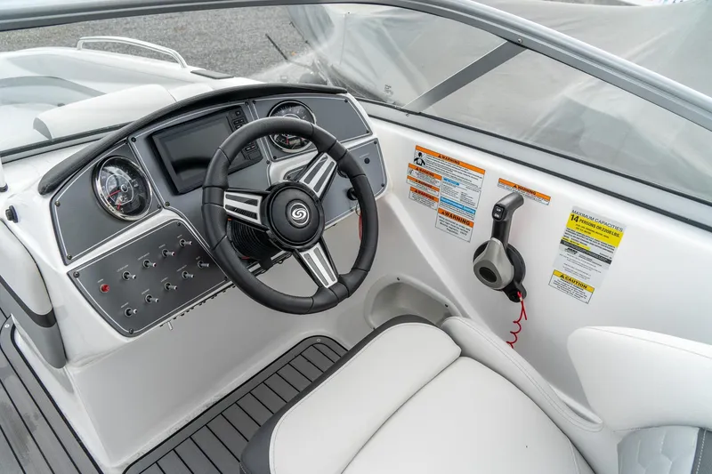 Slide: The Image of 2024 Hurricane SunDeck 217 OB boat dashboard with steering wheel and control panel. - 12