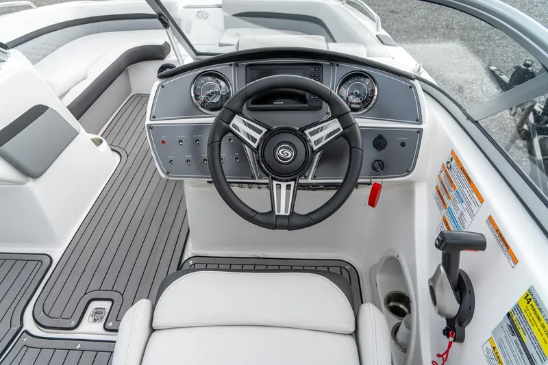 Slide: The Image of 2024 Hurricane SunDeck 217 OB boat cockpit with steering wheel and control panel. - 13