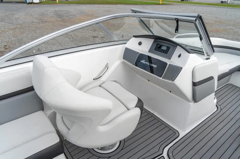 Slide: The Image of 2024 Hurricane SunDeck 217 OB boat interior with sleek white seating and modern dashboard. - 14