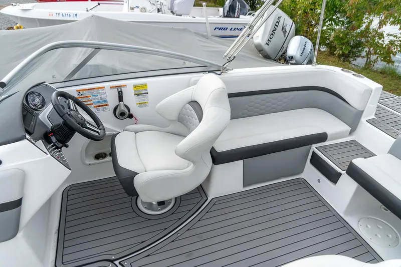 Slide: The Image of 2024 Hurricane SunDeck 217 OB boat interior with sleek seating and modern dashboard. - 21