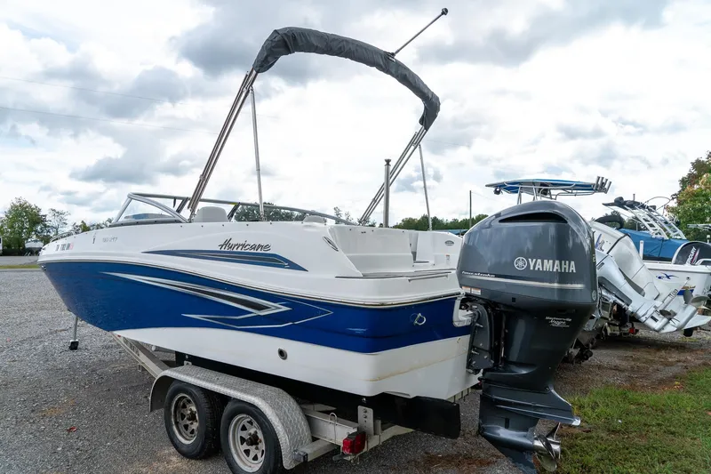 Slide: The Image of 2024 Hurricane SunDeck 217 OB boat with Yamaha outboard motor on trailer. - 3