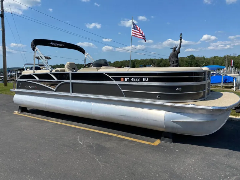 Slide: The Image of 2015 Misty Harbor 2685SU Tri Toon pontoon boat on display with American flag. - 0