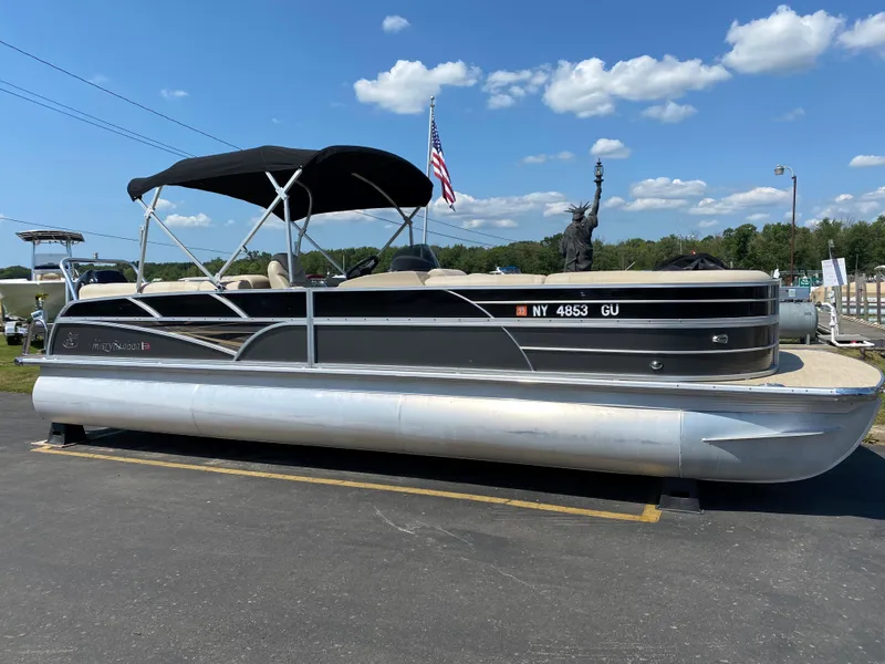 Slide: The Image of 2015 Misty Harbor 2685SU Tri Toon pontoon boat with canopy, parked on asphalt. - 1