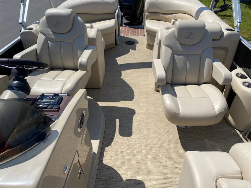 Slide: The Image of 2015 Misty Harbor 2685SU Tri Toon boat interior with beige seating and steering console. - 13