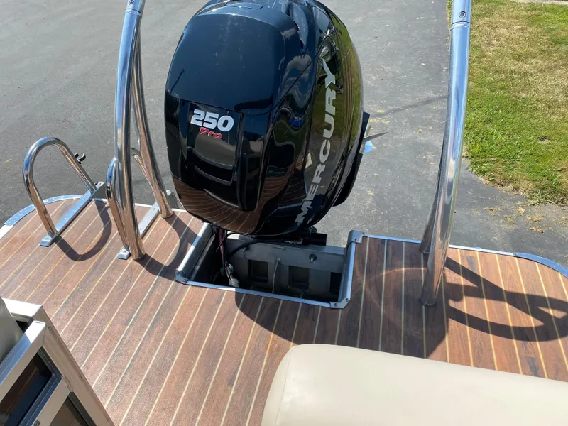 Slide: The Image of 2015 Misty Harbor 2685SU Tri Toon with Mercury 250 engine on wooden deck. - 18