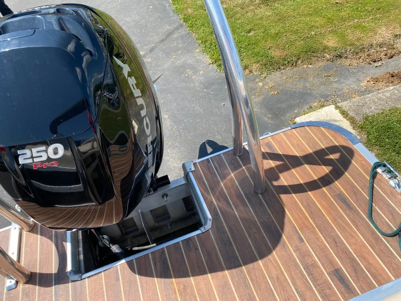 Slide: The Image of 2015 Misty Harbor 2685SU Tri Toon with Mercury 250 Pro outboard motor on wooden deck. - 20