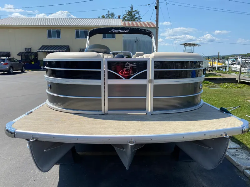 Slide: The Image of 2015 Misty Harbor 2685SU Tri Toon pontoon boat docked under clear sky. - 3