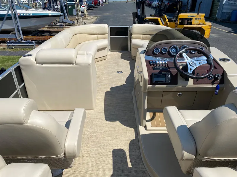 Slide: The Image of 2015 Misty Harbor 2685SU Tri Toon boat interior with beige seating and steering console. - 6