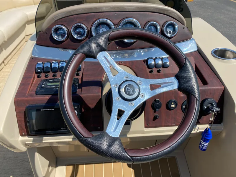 Slide: The Image of Steering wheel and dashboard of 2015 Misty Harbor 2685SU Tri Toon boat. - 9