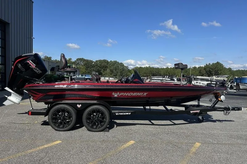 The Image of 2026 Phoenix 920 Elite boat on trailer, parked outdoors under clear blue sky. - 1