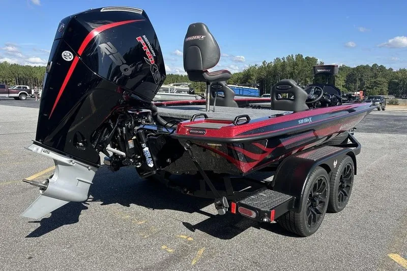 Slide: The Image of 2026 Phoenix 920 Elite boat with powerful outboard motor, parked on a trailer. - 6