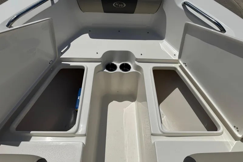 Slide: The Image of 2025 Key West 203 DFS boat interior with open storage compartments and cup holders. - 10