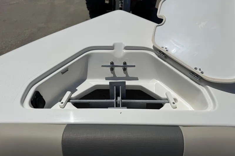 Slide: The Image of Anchor storage compartment on 2025 Key West 203 DFS boat, open lid, white interior. - 11