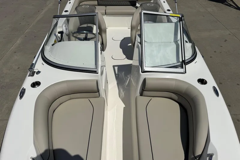 Slide: The Image of 2025 Key West 203 DFS boat interior with beige seating and open windshield. - 13