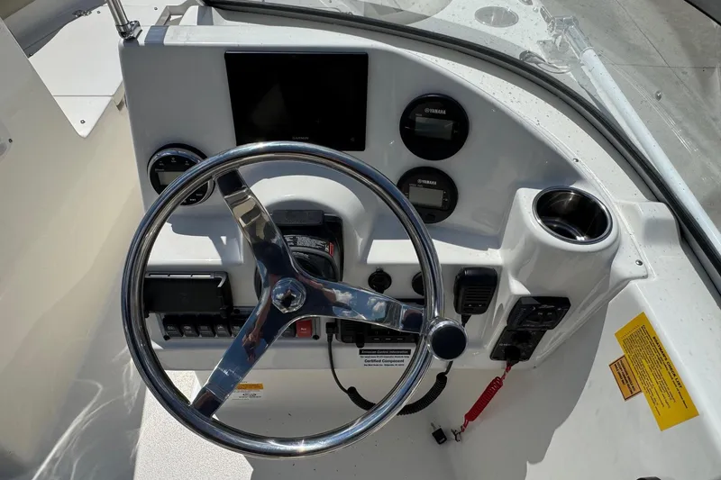 Slide: The Image of Steering console of 2025 Key West 203 DFS boat with gauges and controls. - 16