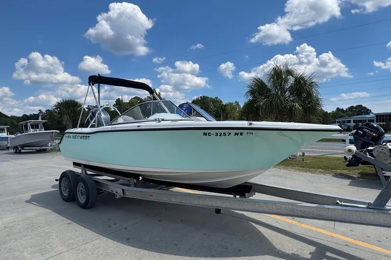 Slide: The Image of 2025 Key West 203 DFS boat on trailer under blue sky with clouds. - 2