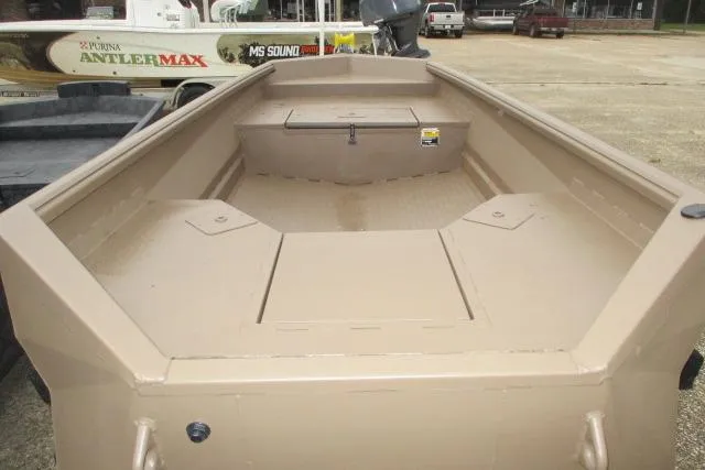 Slide: The Image of 2026 Reaper Boats 550-1691, beige interior, spacious deck, parked outdoors. - 7