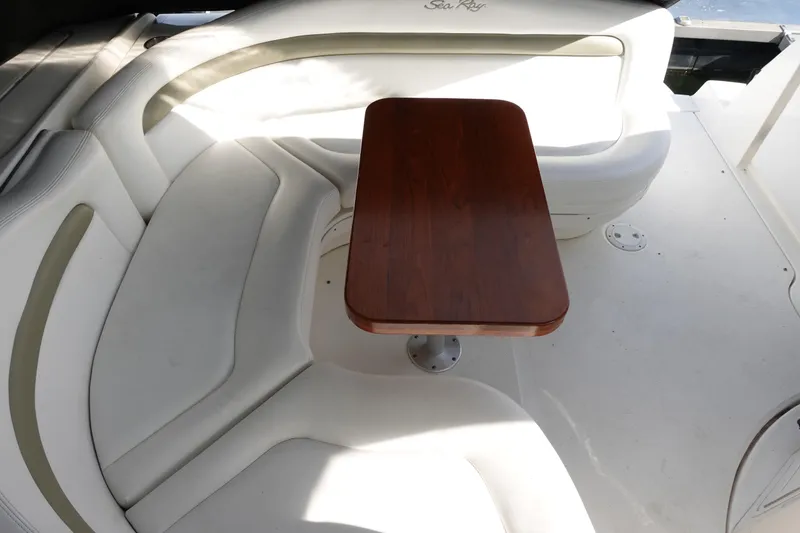 Slide: The Image of 2007 Sea Ray 320 Sundancer interior with white seating and wooden table. - 11