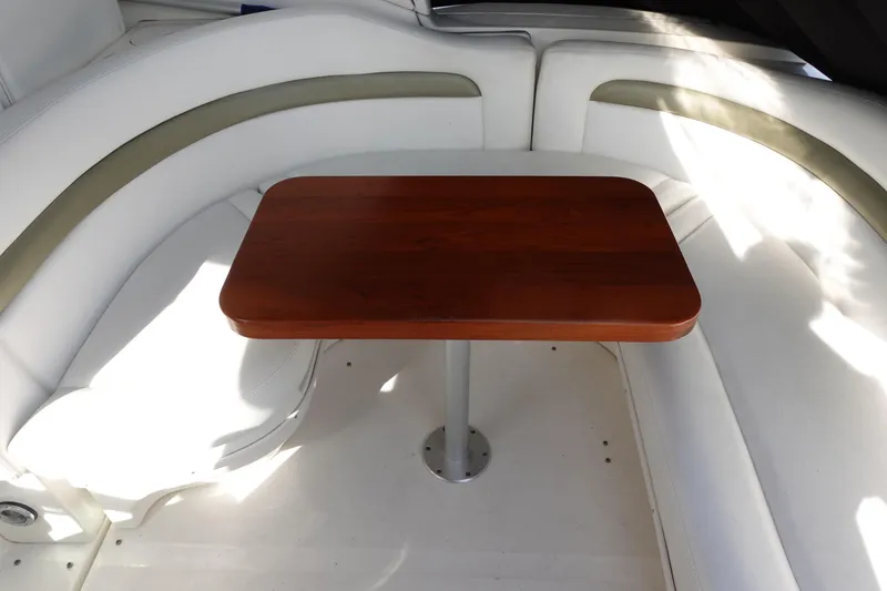 Slide: The Image of Interior of 2007 Sea Ray 320 Sundancer with wooden table and white seating. - 12