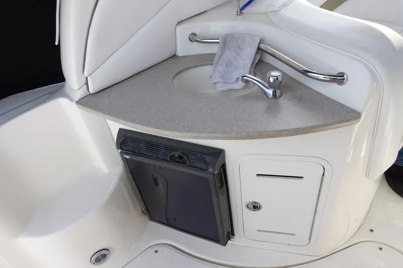 Slide: The Image of 2007 Sea Ray 320 Sundancer boat interior with sink and mini fridge. - 13