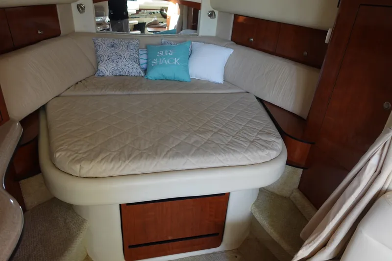 Slide: The Image of 2007 Sea Ray 320 Sundancer cabin with cozy bed and decorative pillows. - 22