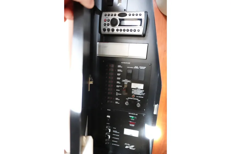 Slide: The Image of Control panel of a 2007 Sea Ray 320 Sundancer boat, featuring various switches and controls. - 23